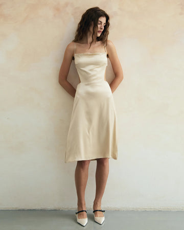Woman wearing a soft ivory dress made of pure silk